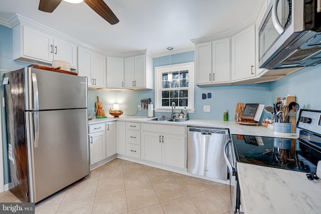 kitchen with pendant lighting, stainless steel appliances, and white cabinets