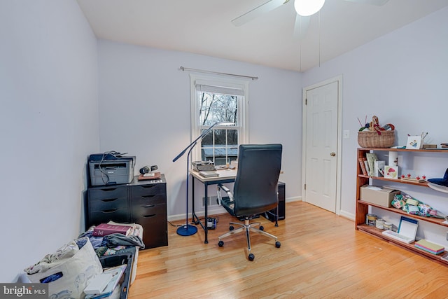 office area featuring a ceiling fan, baseboards, and wood finished floors