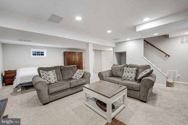 living area with light colored carpet, recessed lighting, visible vents, and stairs