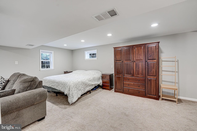 bedroom featuring light carpet, visible vents, and recessed lighting