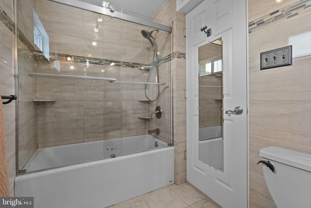 bathroom featuring shower / bath combination with glass door, toilet, and tile patterned floors