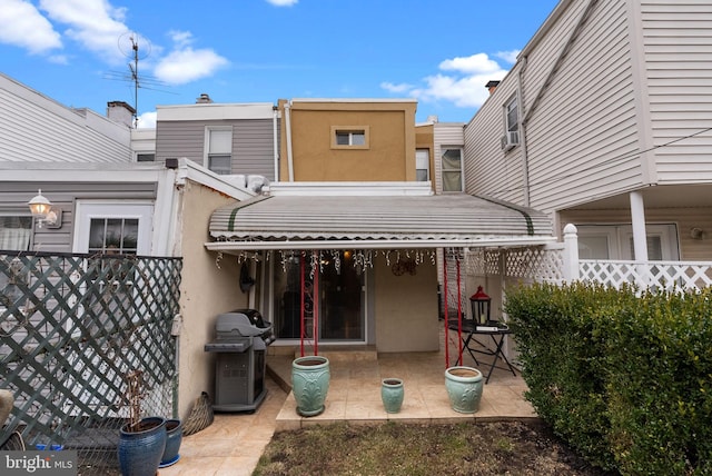 back of property featuring a patio area, fence, and stucco siding