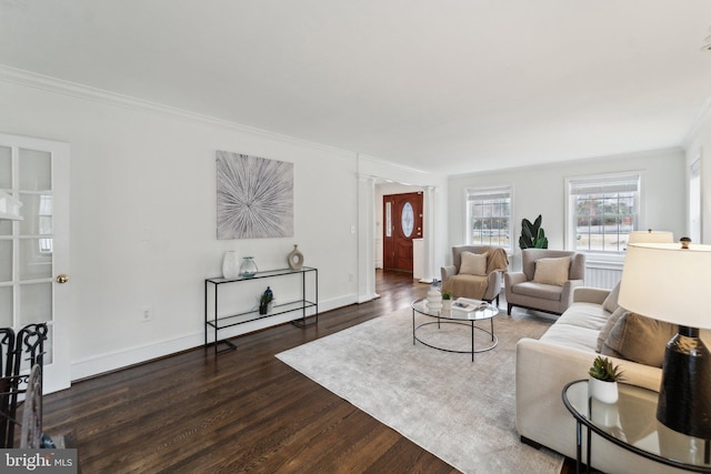 living area with ornamental molding, wood finished floors, and baseboards