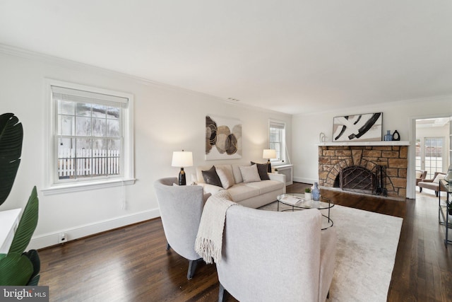 living room with ornamental molding, a fireplace, dark wood finished floors, and baseboards