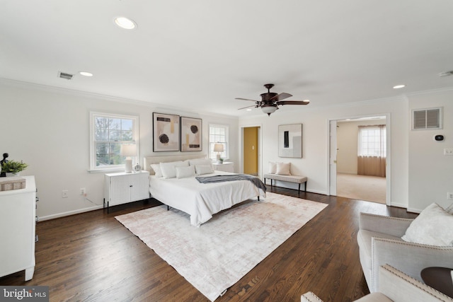 bedroom featuring multiple windows, visible vents, and dark wood-type flooring