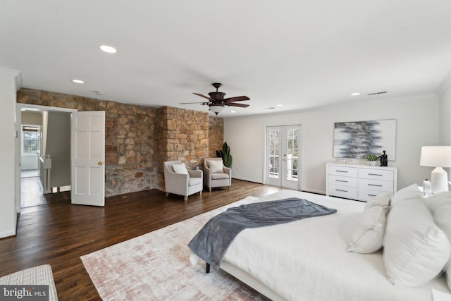 bedroom with access to outside, french doors, multiple windows, and wood finished floors