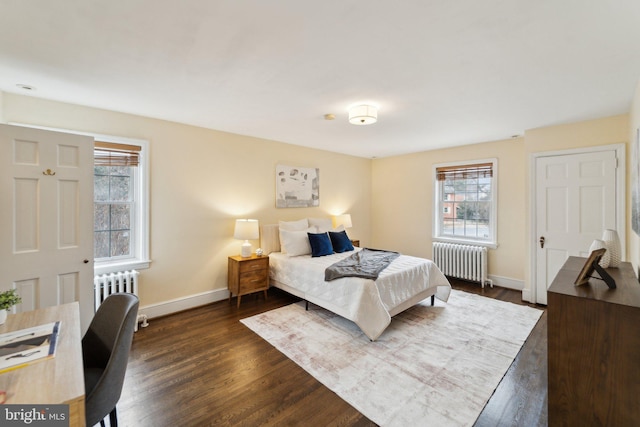 bedroom with radiator heating unit, baseboards, and dark wood finished floors