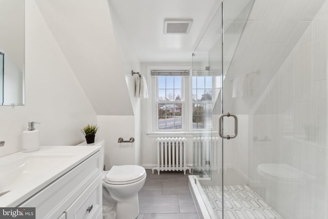 bathroom featuring visible vents, toilet, radiator heating unit, a shower stall, and vanity