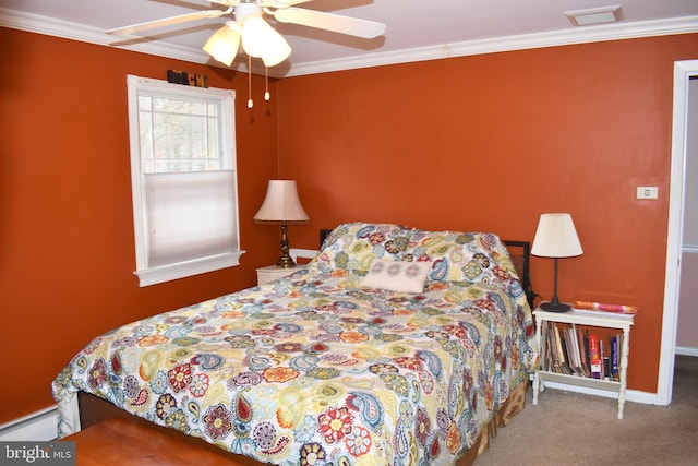 carpeted bedroom featuring visible vents, ornamental molding, baseboard heating, and a ceiling fan