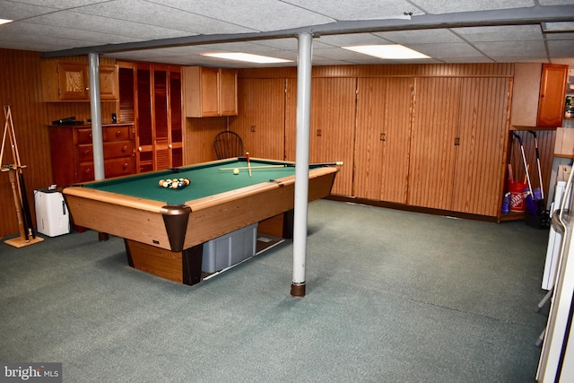 game room with a paneled ceiling, pool table, and wooden walls