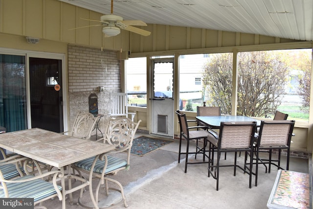 sunroom / solarium with ceiling fan and vaulted ceiling