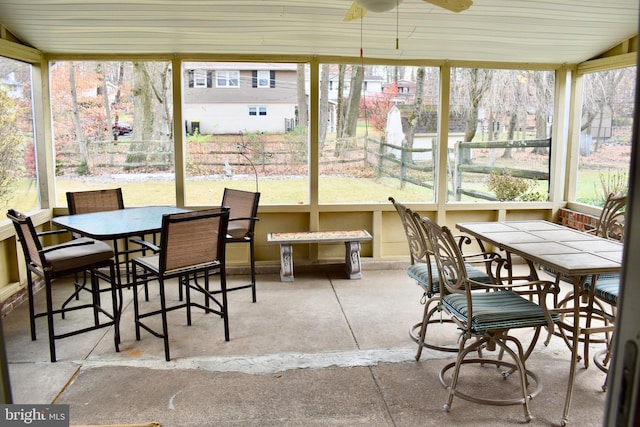 sunroom / solarium featuring a ceiling fan