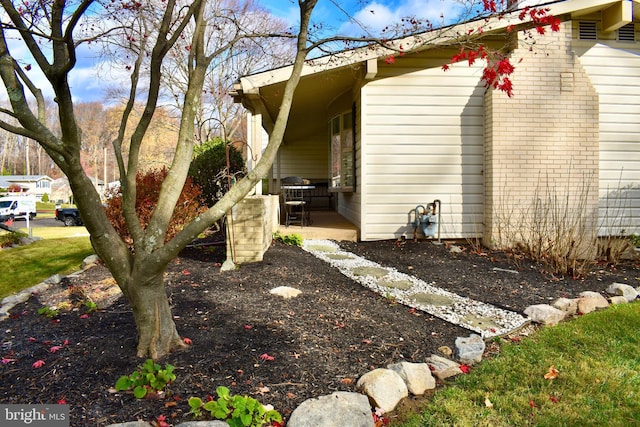 view of home's exterior featuring a patio and brick siding