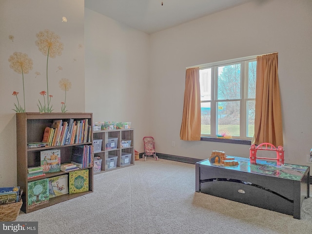 recreation room with carpet floors and baseboards