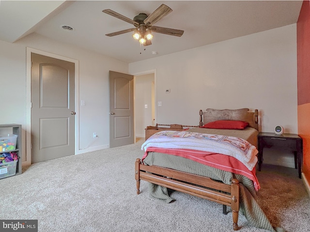 bedroom featuring carpet floors, ceiling fan, visible vents, and baseboards