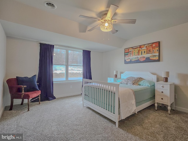 carpeted bedroom with ceiling fan, baseboards, visible vents, and vaulted ceiling