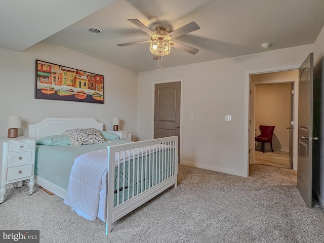 bedroom featuring a ceiling fan, light carpet, visible vents, and baseboards