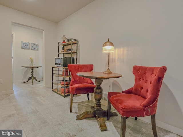 living area featuring baseboards