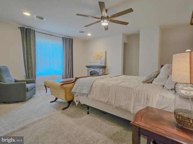 bedroom featuring recessed lighting, a fireplace, carpet flooring, a ceiling fan, and visible vents