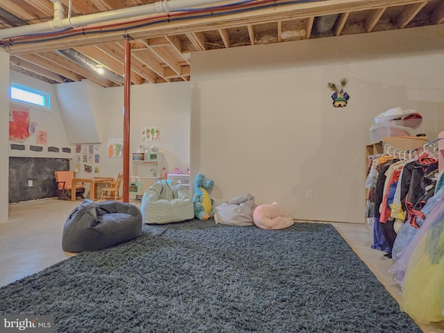 recreation room with concrete flooring