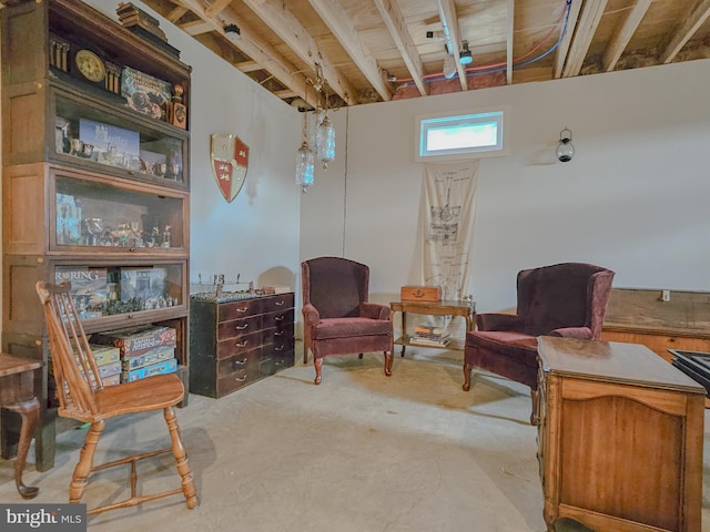 sitting room featuring concrete flooring