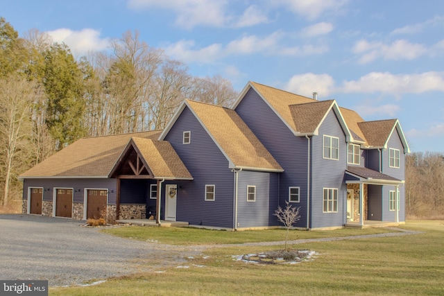 view of front facade with a garage, stone siding, a front lawn, and roof with shingles