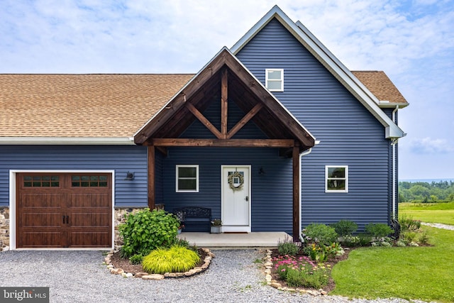9493 Rte 235, Beavertown, PA 17813 - view of front of property with a garage, a porch, driveway, and roof with shingles