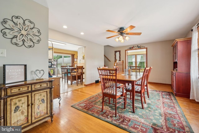 dining space with light wood finished floors, baseboards, a wealth of natural light, and recessed lighting