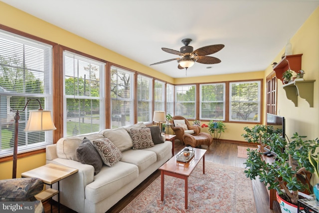 sunroom featuring ceiling fan