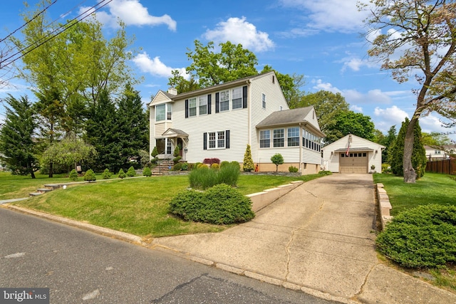 colonial house featuring an outbuilding, a detached garage, a chimney, driveway, and a front lawn