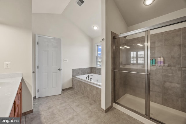 full bathroom with vanity, visible vents, vaulted ceiling, a bath, and a stall shower