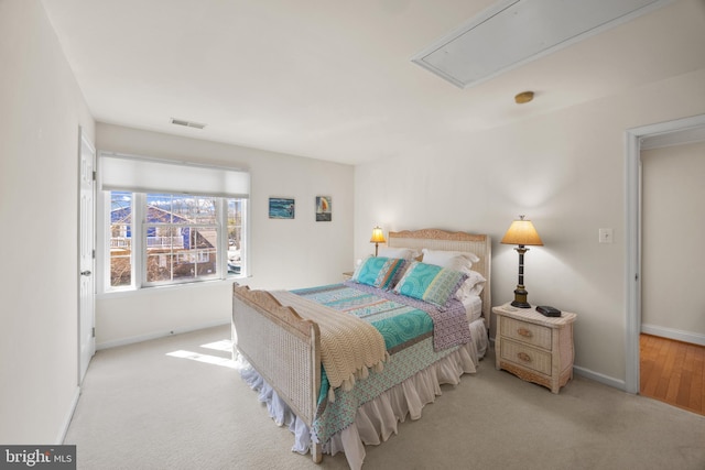 bedroom with visible vents, carpet, attic access, and baseboards