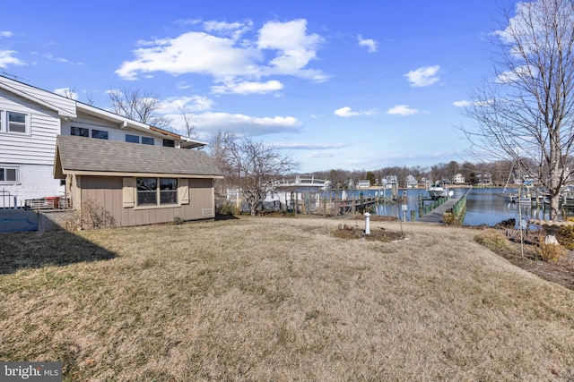 view of yard featuring a boat dock and a water view