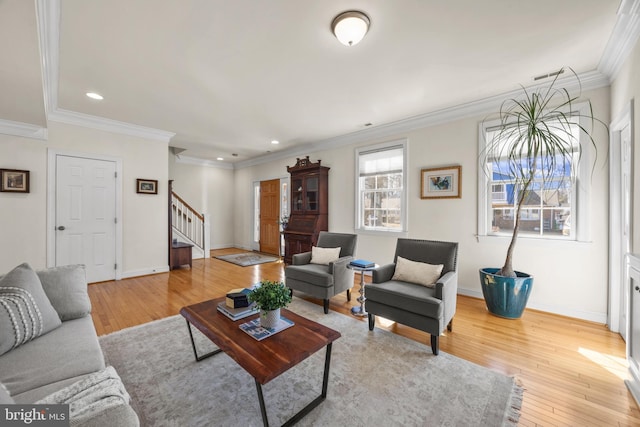 living area featuring recessed lighting, baseboards, stairs, light wood-style floors, and ornamental molding