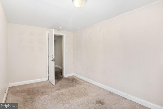 unfurnished bedroom featuring carpet floors and baseboards