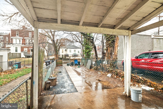 view of patio / terrace featuring fence and a residential view