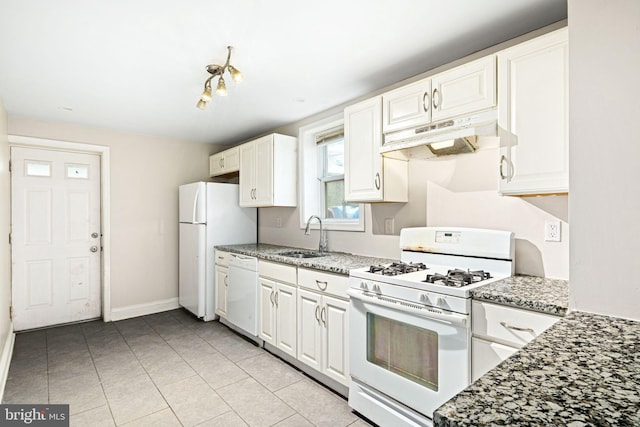 kitchen featuring white appliances, light tile patterned floors, baseboards, white cabinets, and under cabinet range hood