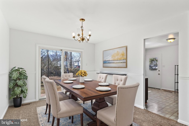 dining area with an inviting chandelier, baseboards, visible vents, and light colored carpet