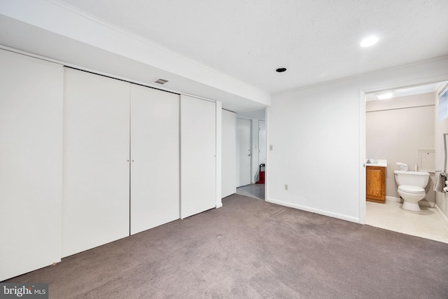9621 E Bexhill Dr, Kensington, MD 20895 - unfurnished bedroom with a closet, ensuite bath, carpet flooring, and visible vents