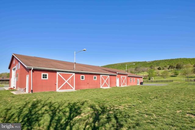 exterior space with a lawn and fence