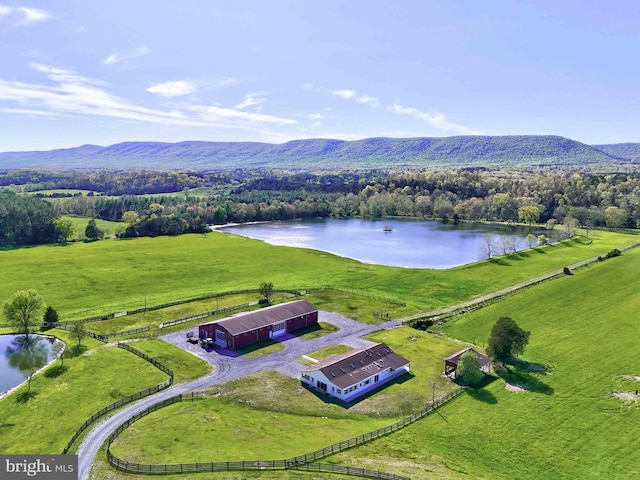 aerial view featuring a water and mountain view and a rural view