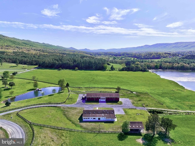 bird's eye view featuring a water and mountain view, a rural view, and a wooded view