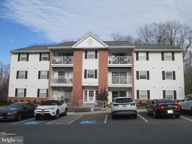 view of building exterior with uncovered parking