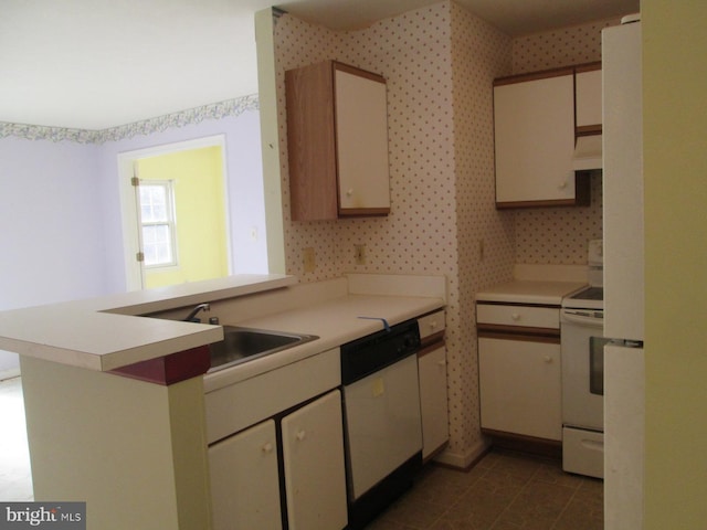 kitchen with white appliances, light countertops, a peninsula, wallpapered walls, and premium range hood