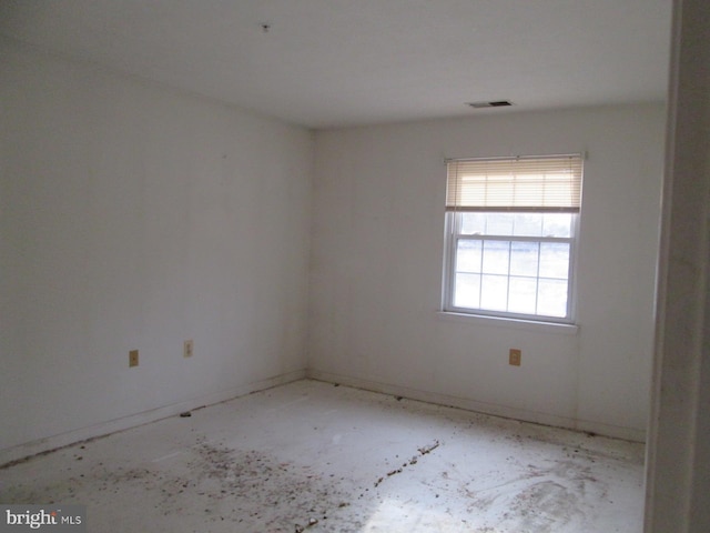 spare room with baseboards