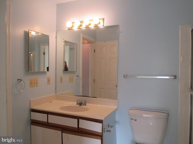 bathroom with toilet and vanity