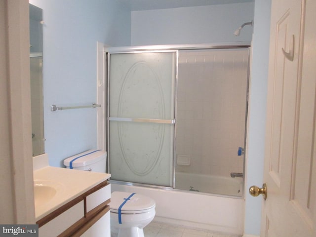 bathroom featuring vanity, toilet, enclosed tub / shower combo, and tile patterned floors