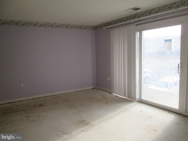 spare room with baseboards