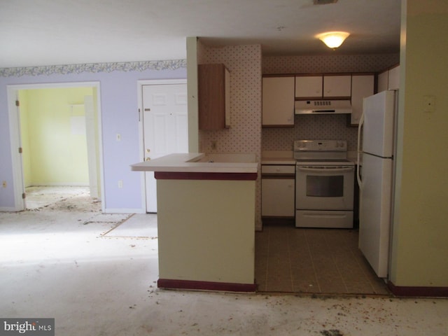 kitchen with white appliances, under cabinet range hood, light countertops, and a peninsula