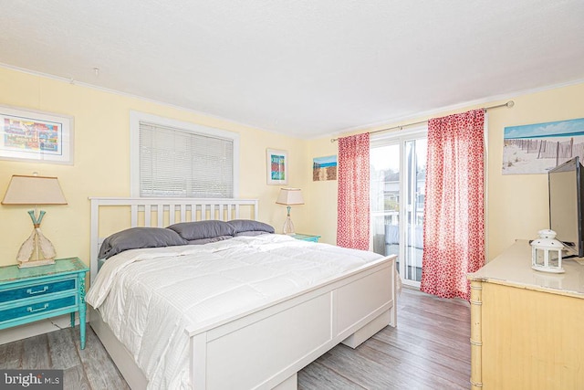 bedroom with ornamental molding and light wood finished floors